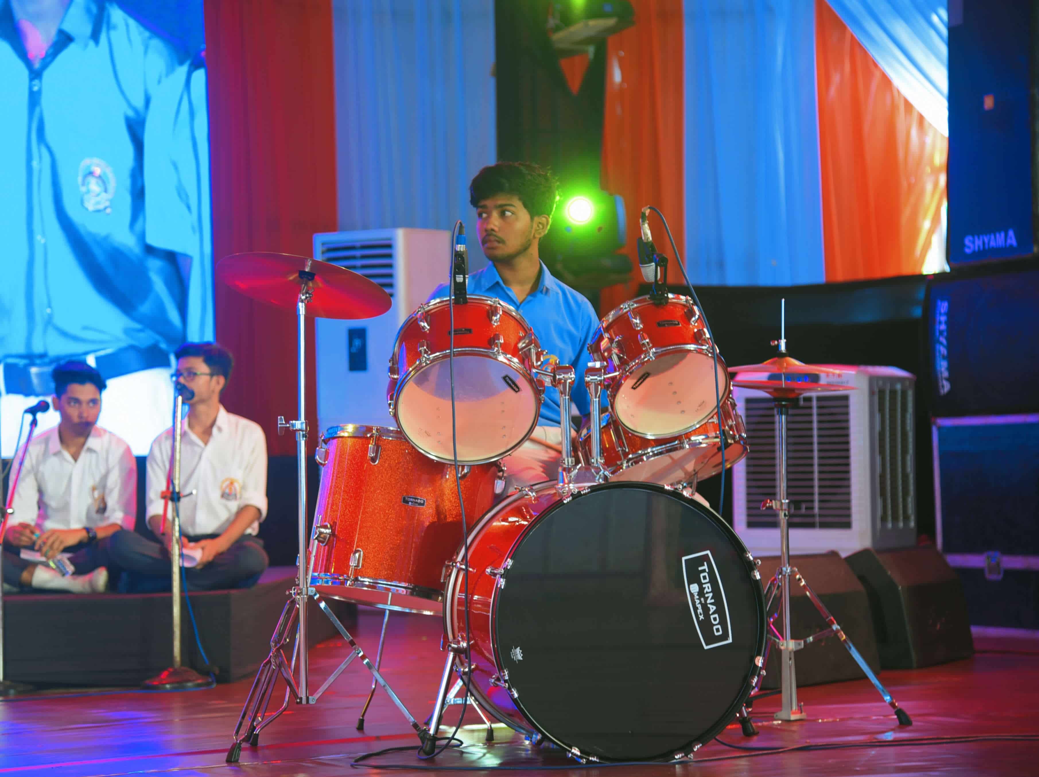Amrin Nimeson playing the drums during a live performance