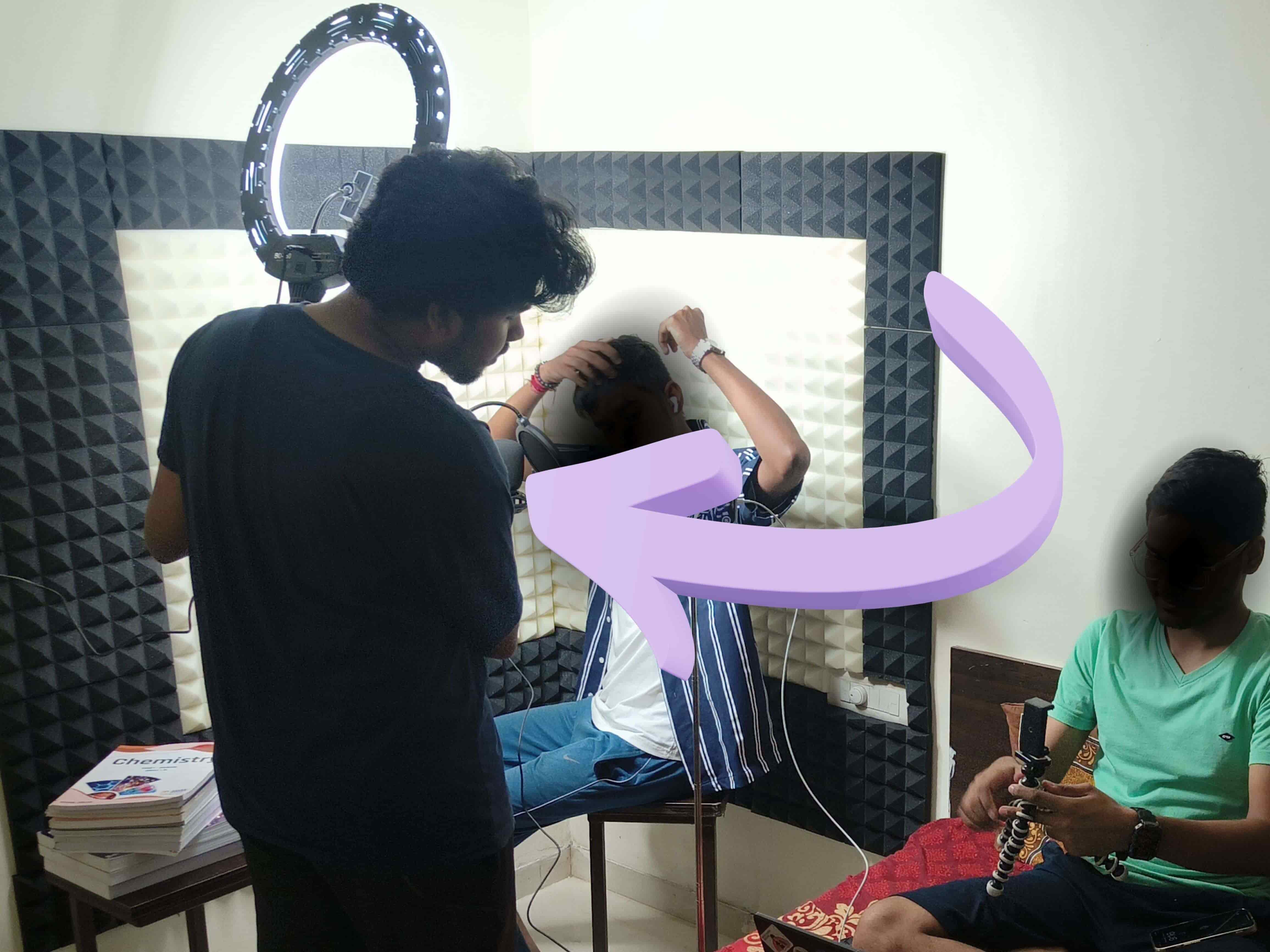 Amrin Nimeson behind the scenes of a video production and lighting setup